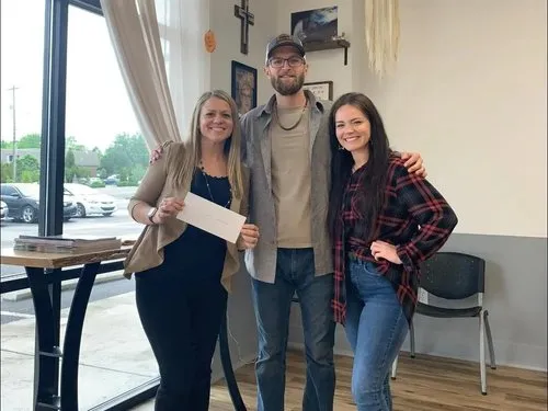 Alexis Goines celebrates a community gift with local friends.