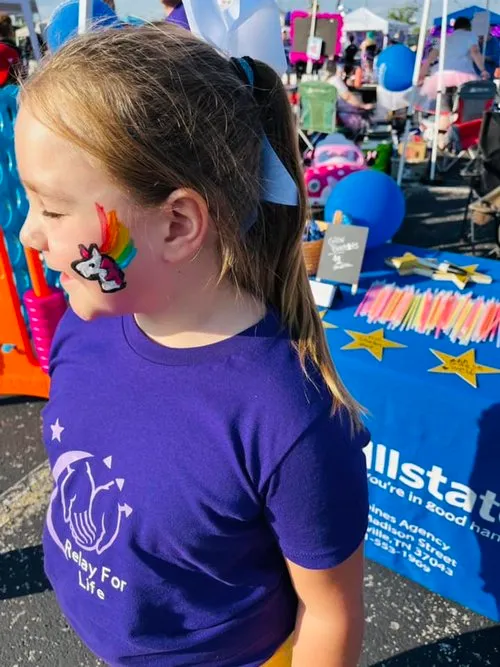 A young member of the Goines Agency family enjoys face paint at Relay For Life.