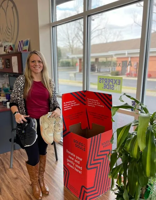 Alexis Goines helps collect gently used shoes for the Soles4Souls drive.