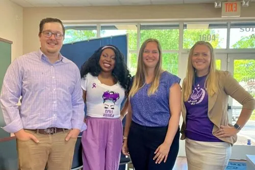 Community advocates gather in purple for a day of awareness and connection.