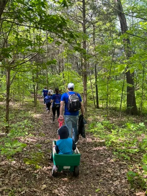 Young members of the Goines Agency family join the group for a walk through the woods.